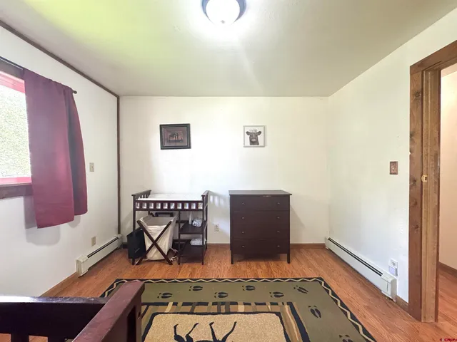 a view of room with window and wooden floor