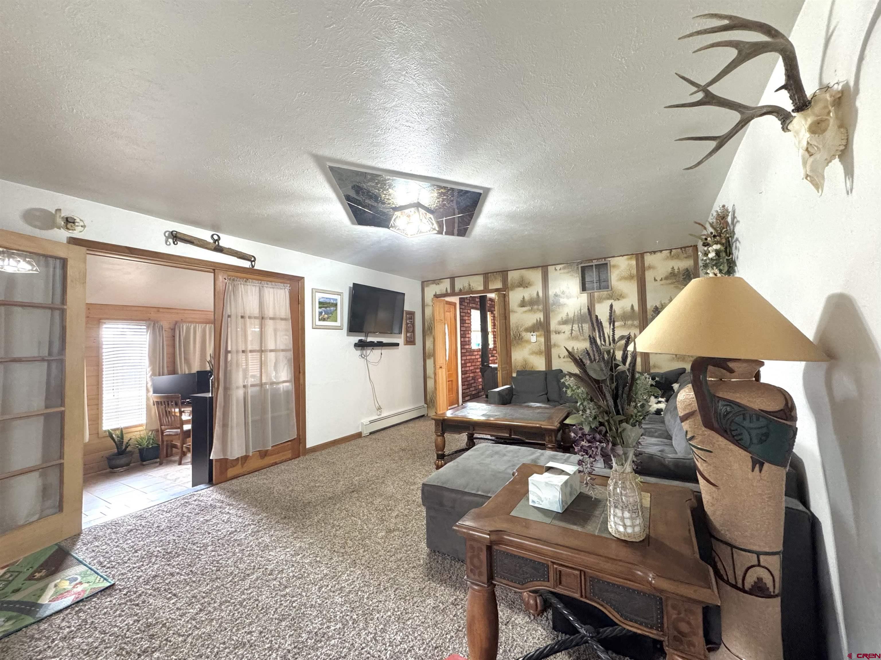 113 Conejos Street Romeo, CO 81148 - Photo 33 of 36 a living room with furniture and a large window