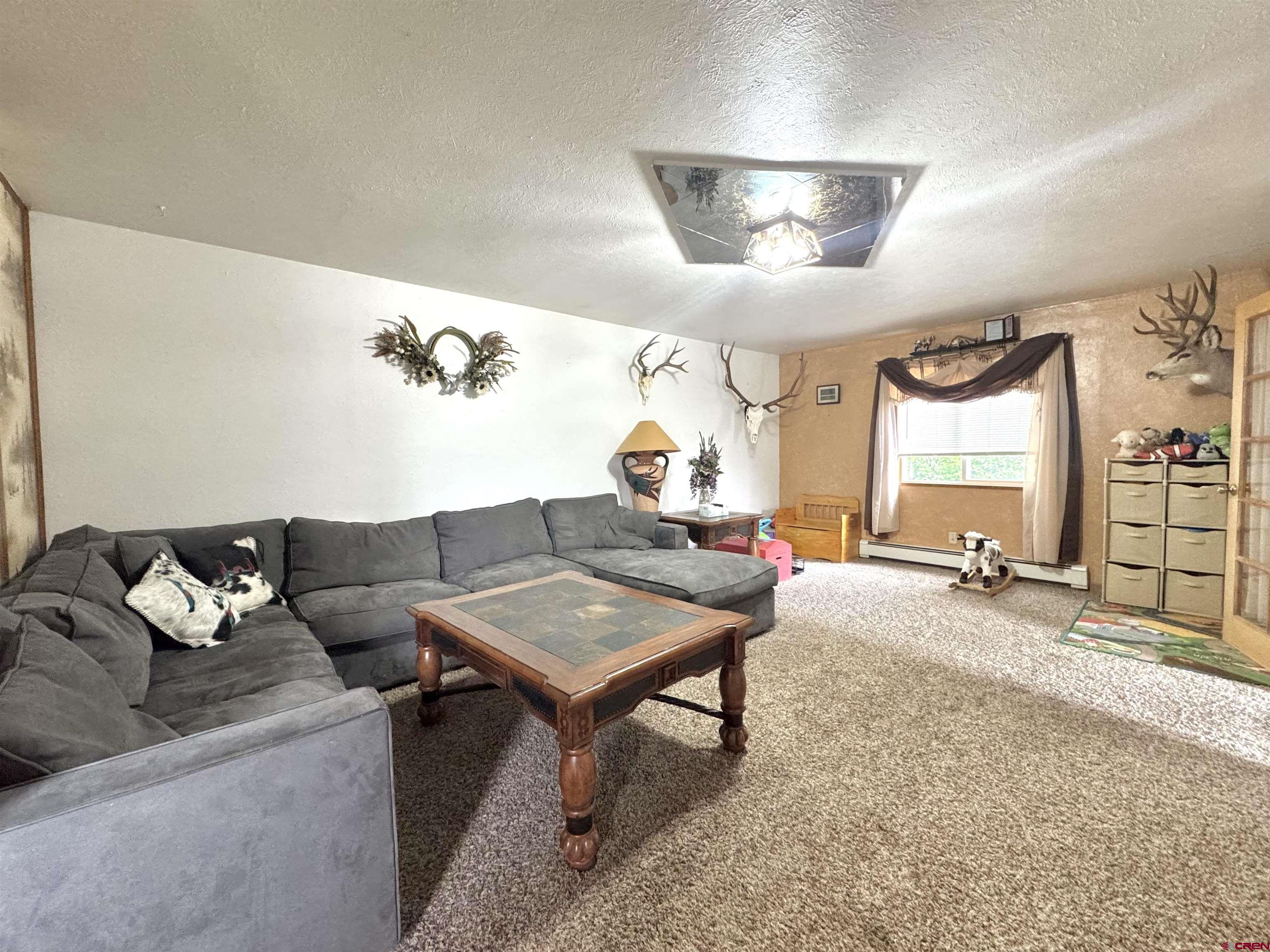 113 Conejos Street Romeo, CO 81148 - Photo 35 of 36 a living room with furniture and a flat screen tv