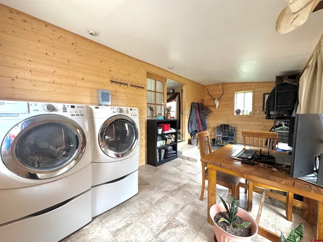a utility room with sink dryer and washer