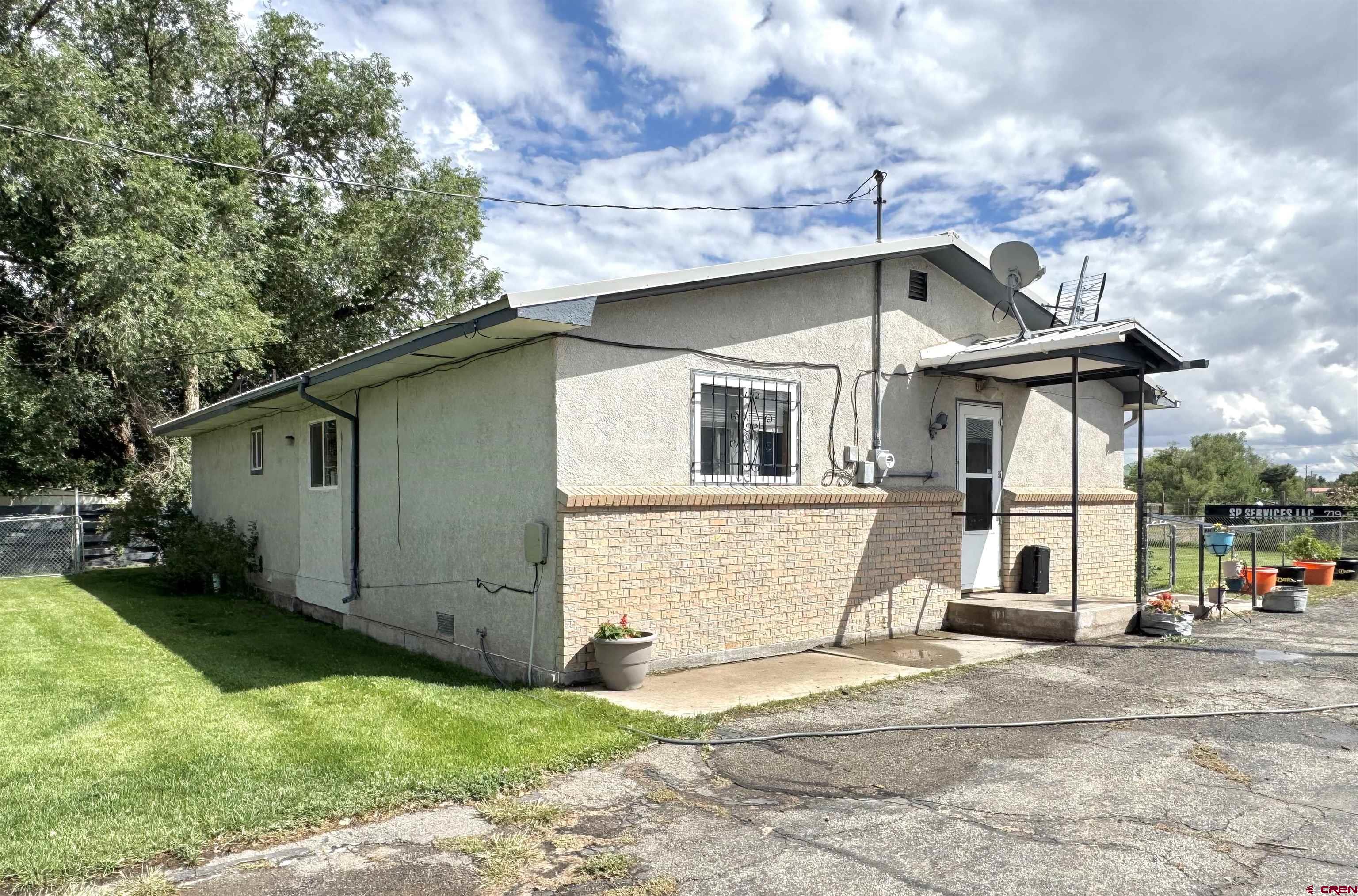 113 Conejos Street Romeo, CO 81148 - Photo 5 of 36 a front view of a house with garden