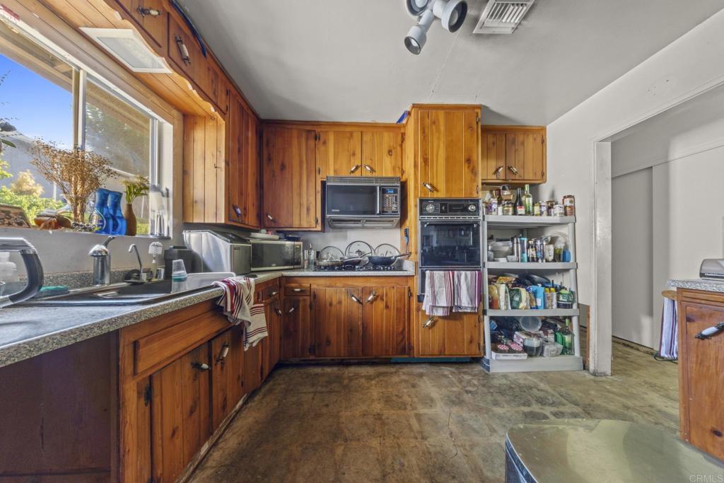 8552 Brodie Lane Santee, CA 92071 - Photo 26 of 40 a kitchen with stainless steel appliances granite countertop a sink stove and cabinets