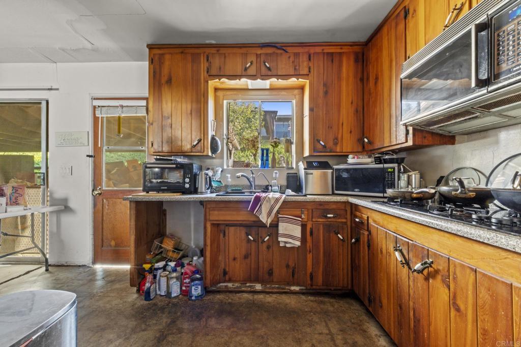 8552 Brodie Lane Santee, CA 92071 - Photo 27 of 40 a kitchen with stainless steel appliances a sink stove and a refrigerator