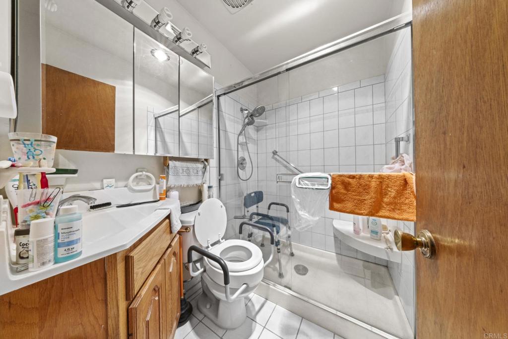 8552 Brodie Lane Santee, CA 92071 - Photo 30 of 40 a bathroom with a sink a mirror and shower