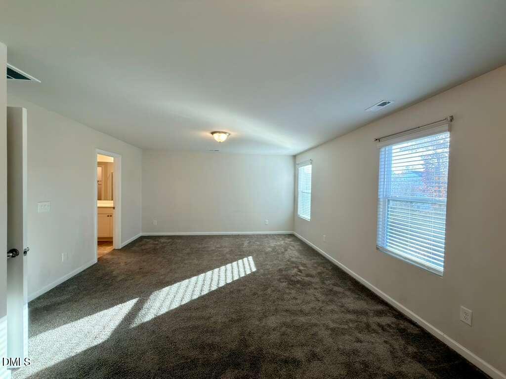 1152 Chestnut Bluff Run Apex, NC 27502 - Photo 20 of 35 a view of an empty room with a window