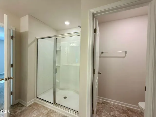 a bathroom with a glass shower door