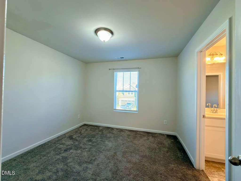 1152 Chestnut Bluff Run Apex, NC 27502 - Photo 31 of 35 an empty room with a window