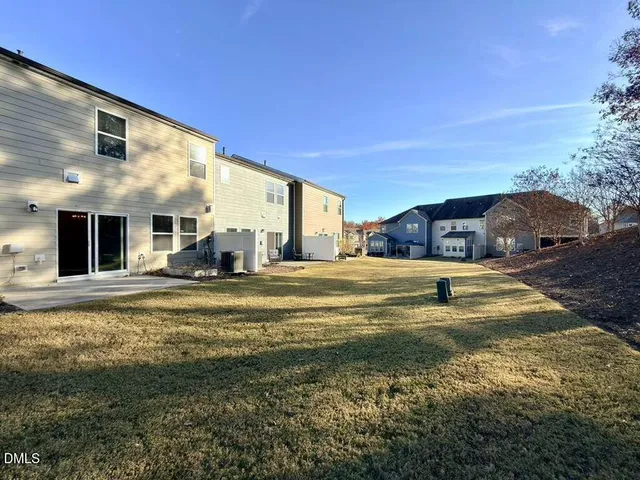 a swimming pool with outdoor seating and yard