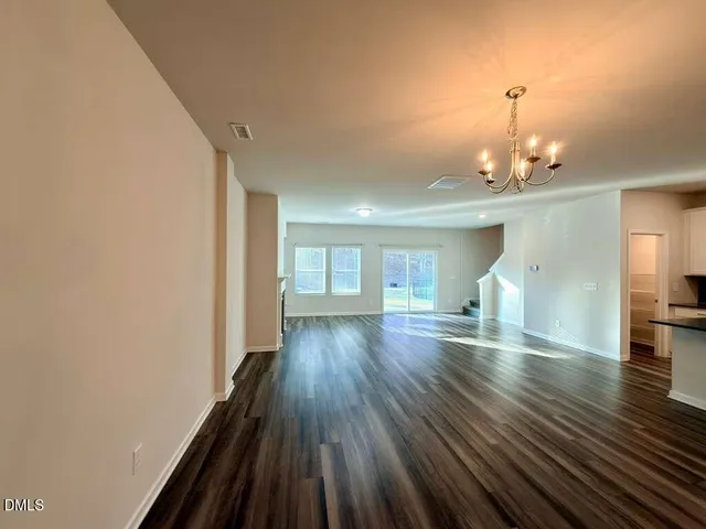 a view of a room with wooden floor