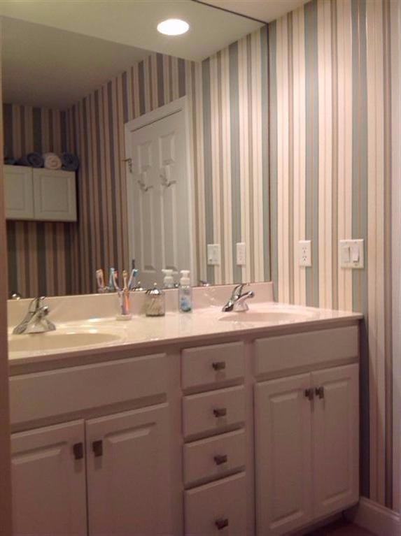 26 Prestwick Road, Unit 186 Bourne, MA 02532 - Photo 17 of 35 a bathroom with a sink and a mirror