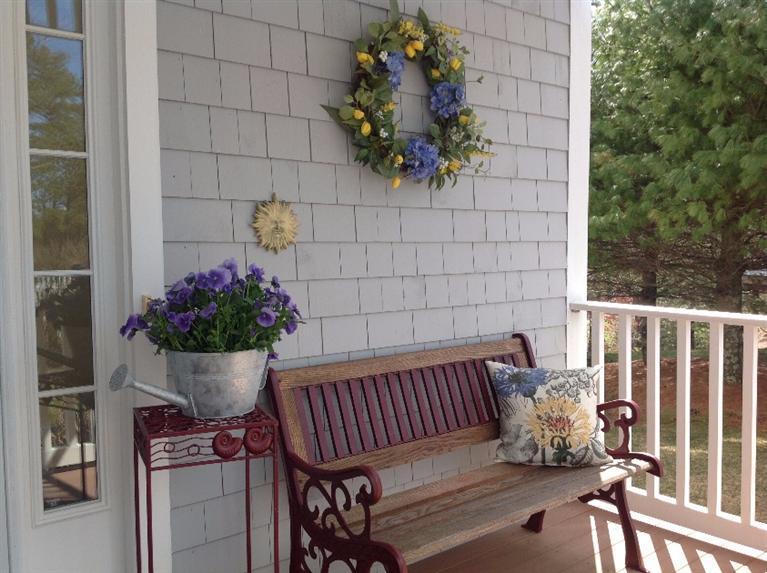 26 Prestwick Road, Unit 186 Bourne, MA 02532 - Photo 2 of 35 a view of a porch with a bench