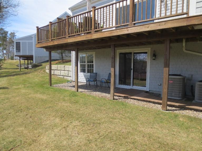 26 Prestwick Road, Unit 186 Bourne, MA 02532 - Photo 31 of 35 a view of a house with a porch and furniture