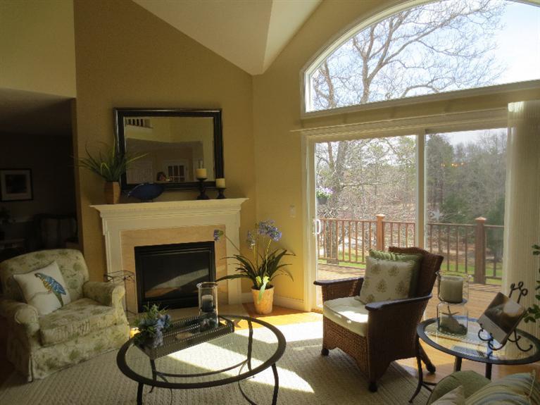 26 Prestwick Road, Unit 186 Bourne, MA 02532 - Photo 5 of 35 a living room with furniture a fireplace and a floor to ceiling window