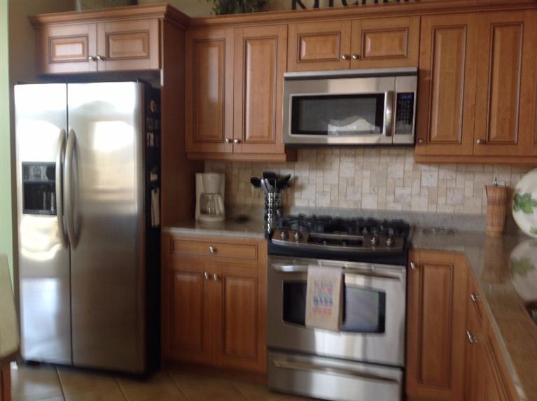 26 Prestwick Road, Unit 186 Bourne, MA 02532 - Photo 8 of 35 a kitchen with granite countertop a stove and a microwave