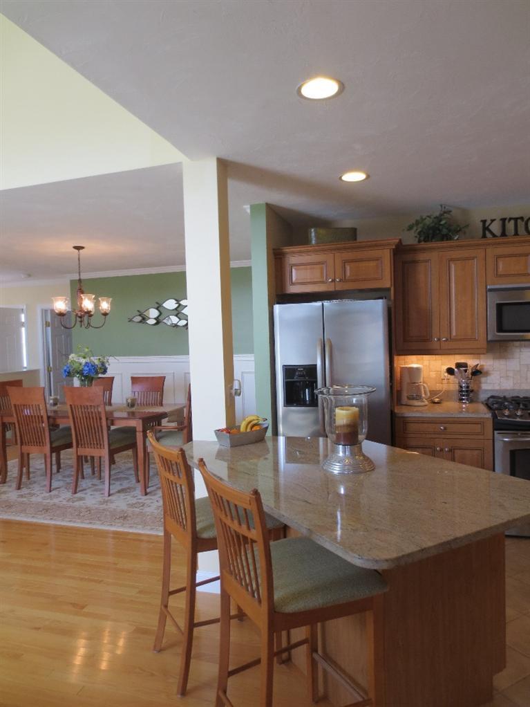 26 Prestwick Road, Unit 186 Bourne, MA 02532 - Photo 10 of 35 a kitchen with kitchen island granite countertop wooden cabinets a counter top space and stainless steel appliances