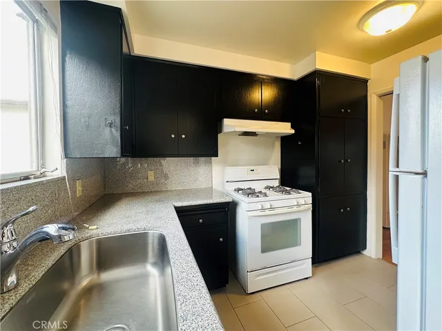 a kitchen with a stove and a refrigerator