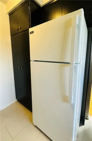 a white refrigerator freezer sitting in a kitchen