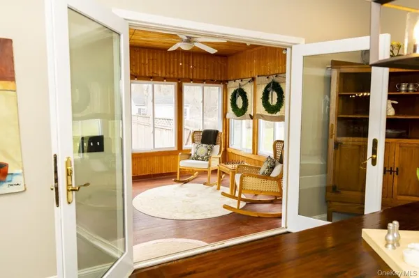a view of a livingroom with furniture window and wooden floor