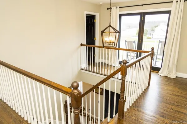 a view of staircase with wooden floor and a window
