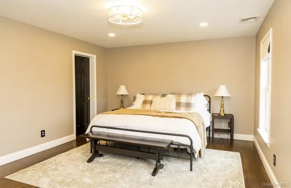 a bedroom with a bed and a table