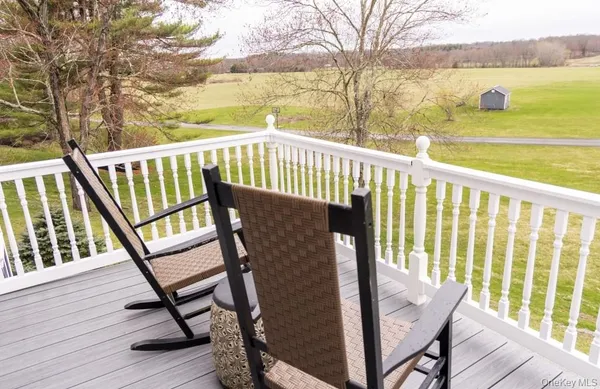 a view of a balcony with chairs