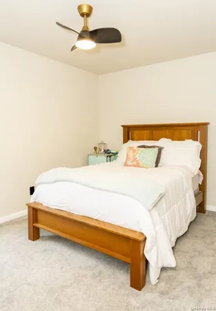 a bedroom with a bed and a ceiling fan