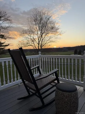 a view of balcony with wooden floor and outdoor seating