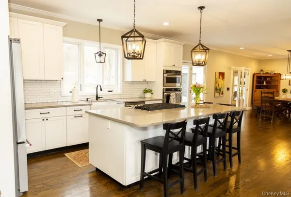 a large kitchen with lots of counter space and dining table