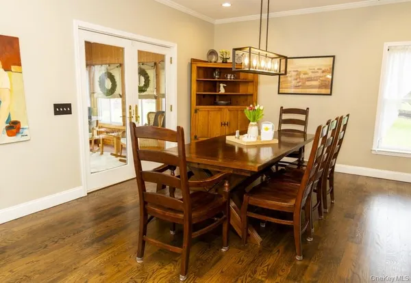 a dining room with furniture and wooden floor
