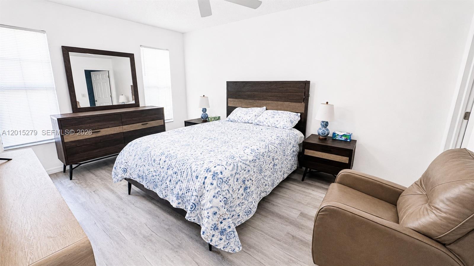 5339 Treetops Drive, Unit 5339 Naples, FL 34113 - Photo 13 of 20 a bedroom with a bed couch and window
