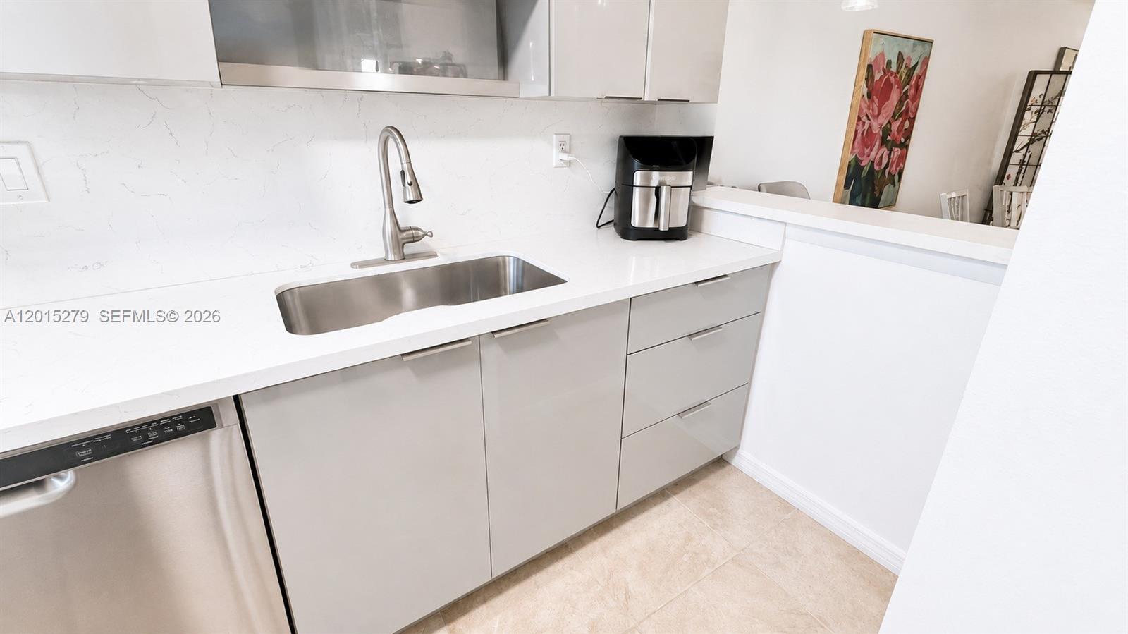 5339 Treetops Drive, Unit 5339 Naples, FL 34113 - Photo 14 of 20 a kitchen with a sink and a refrigerator