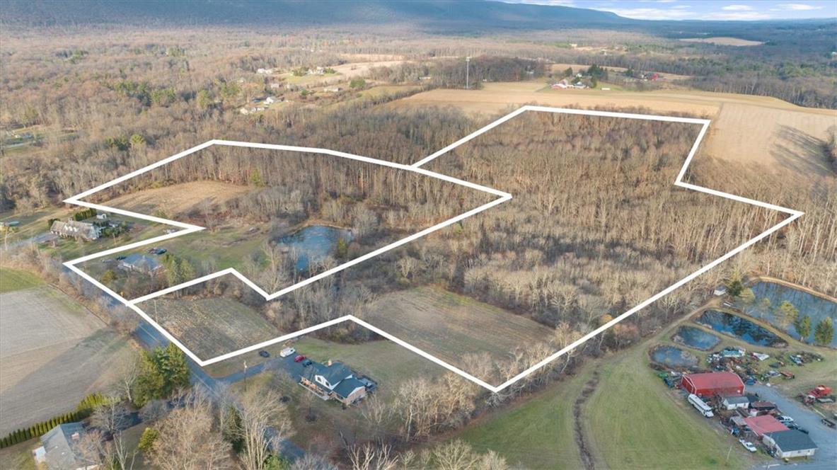 988 Hoch Road Danielsville, PA 18038 - Photo 26 of 29 An aerial perspective reveals a vast land parcel featuring woodlands, open fields, and serene ponds.
