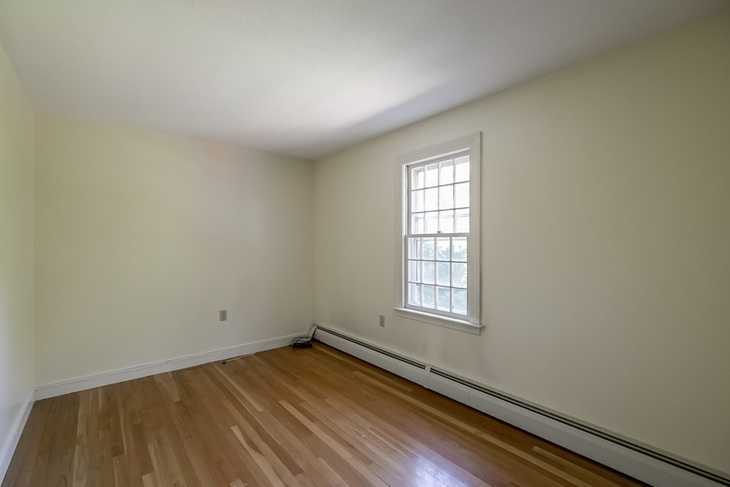 413 Harvard Road Bolton, MA 01740 - Photo 14 of 25 an empty room with wooden floor and windows