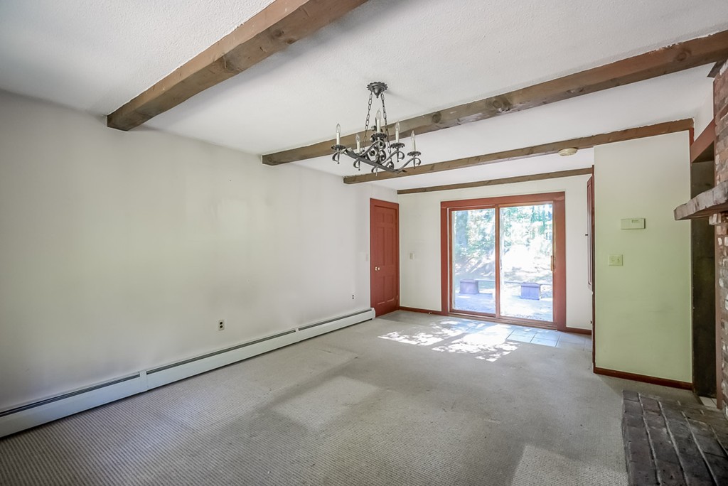 413 Harvard Road Bolton, MA 01740 - Photo 4 of 25 a view of a big room with windows and chandelier