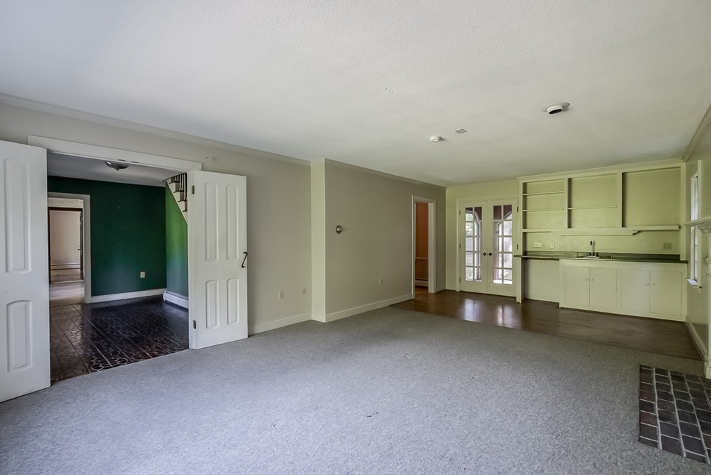 413 Harvard Road Bolton, MA 01740 - Photo 9 of 25 a view of an empty room with kitchen and a window