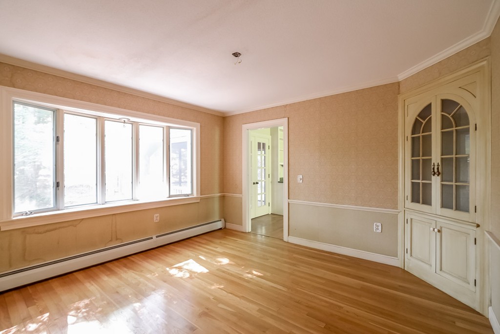 413 Harvard Road Bolton, MA 01740 - Photo 10 of 25 a view of an empty room with a window and wooden floor