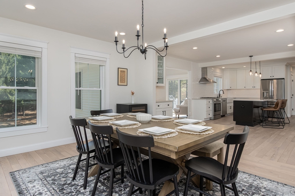 5 Mill Street Dunstable, MA 01827 - Photo 12 of 42 a view of a dining room with furniture a chandelier and wooden floor