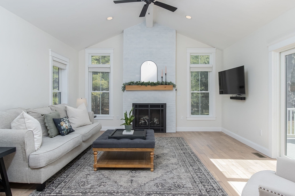 5 Mill Street Dunstable, MA 01827 - Photo 13 of 42 a living room with furniture a fireplace and a flat screen tv