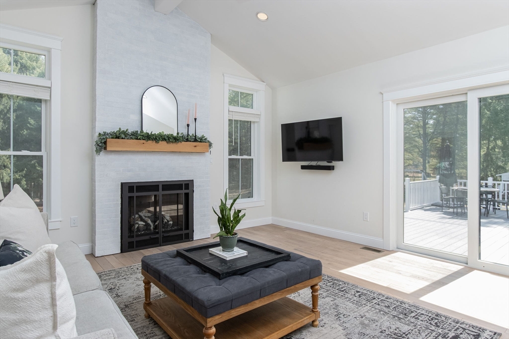 5 Mill Street Dunstable, MA 01827 - Photo 14 of 42 a living room with furniture a flat screen tv and a fireplace