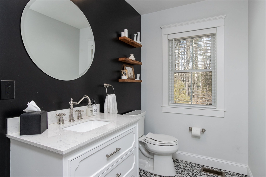 5 Mill Street Dunstable, MA 01827 - Photo 16 of 42 a bathroom with a toilet sink and mirror