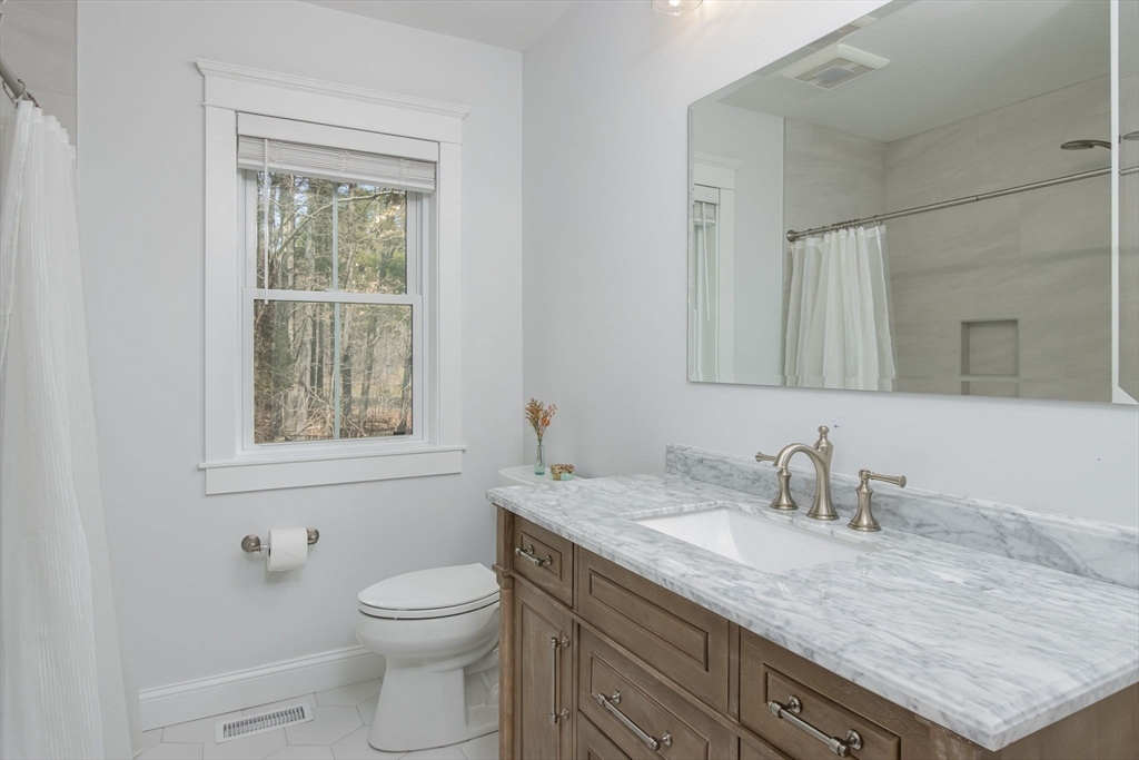 5 Mill Street Dunstable, MA 01827 - Photo 19 of 42 a bathroom with a granite countertop sink toilet and mirror