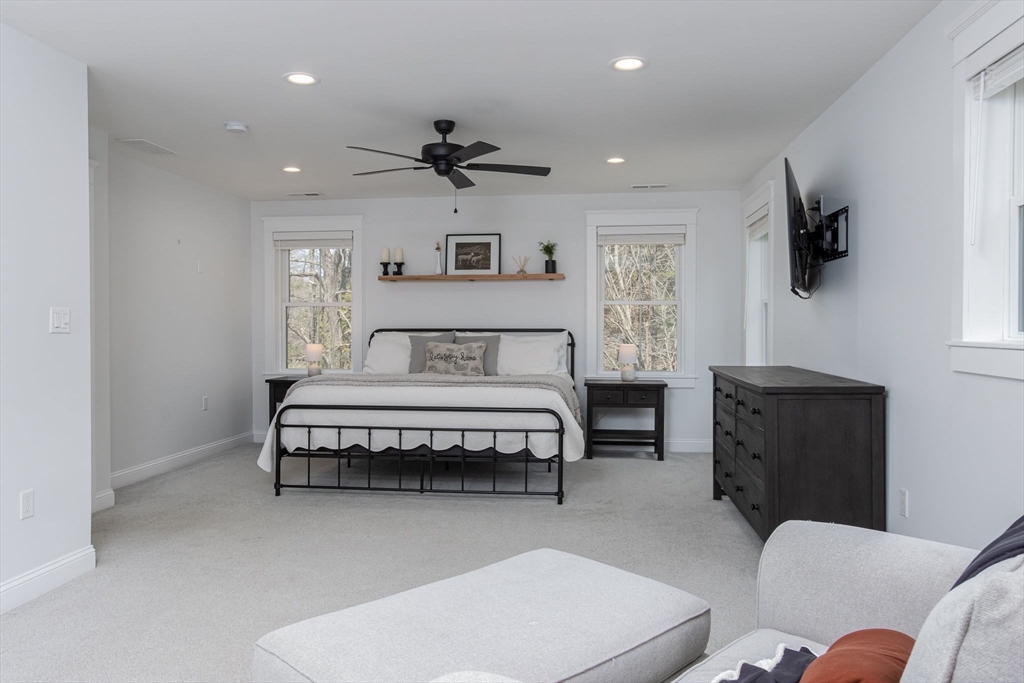 5 Mill Street Dunstable, MA 01827 - Photo 22 of 42 a spacious bedroom with a bed and a flat screen tv