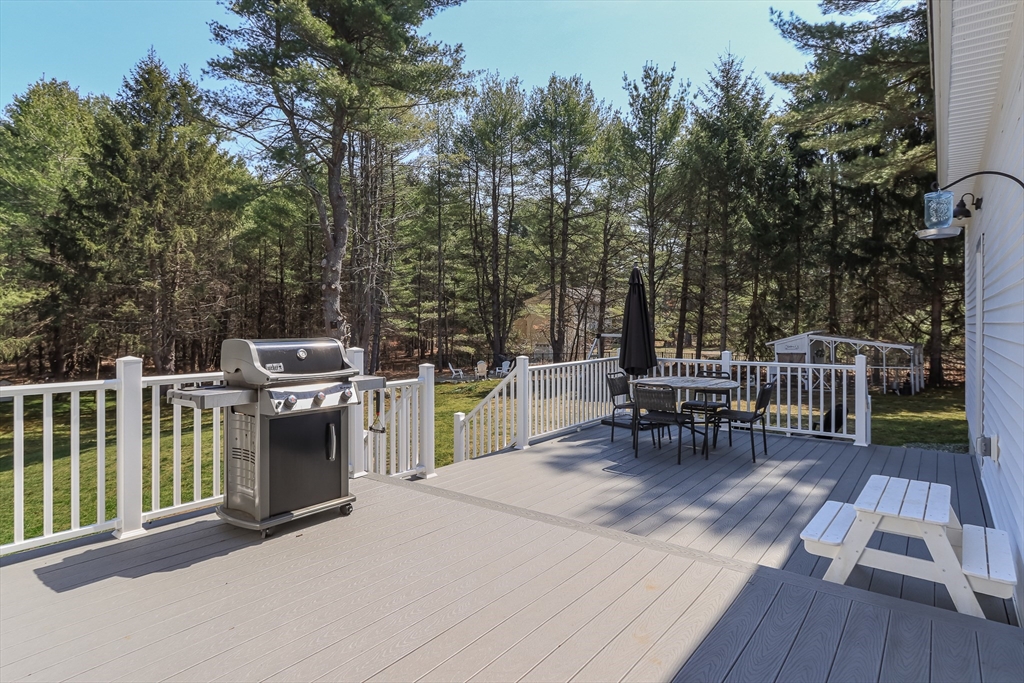 5 Mill Street Dunstable, MA 01827 - Photo 38 of 42 a view of a chairs and table on the wooden deck