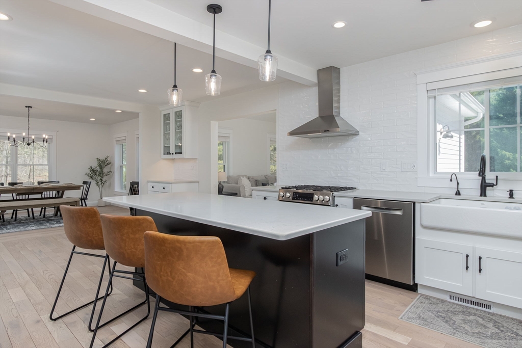 5 Mill Street Dunstable, MA 01827 - Photo 4 of 42 a kitchen with stainless steel appliances granite countertop a sink a stove and a refrigerator
