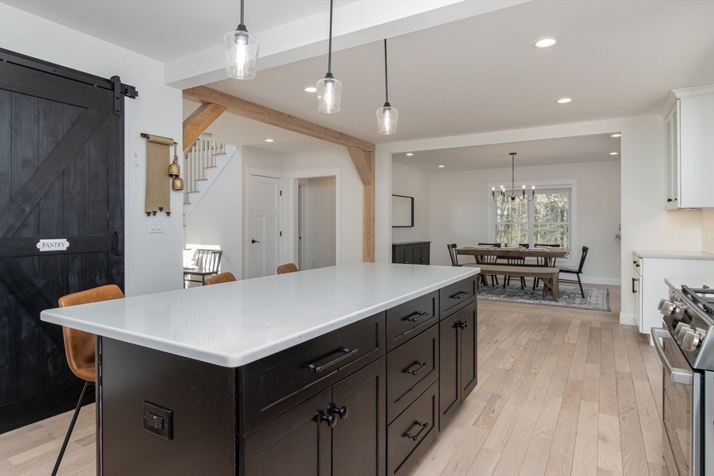 5 Mill Street Dunstable, MA 01827 - Photo 8 of 42 an open kitchen with a table and chairs