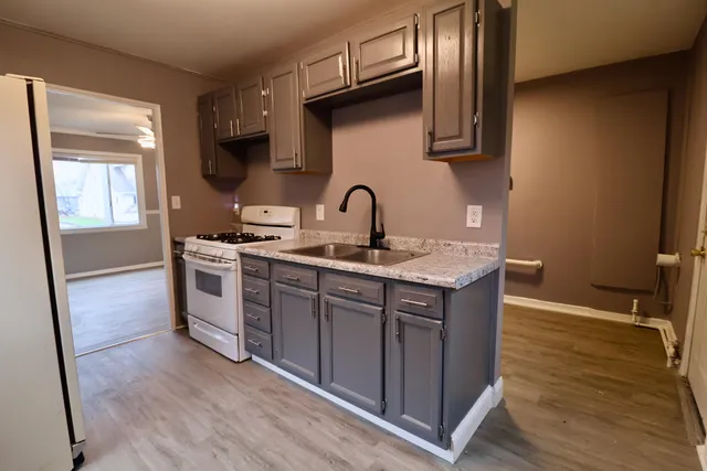 a view of a room that has a window and wooden floor