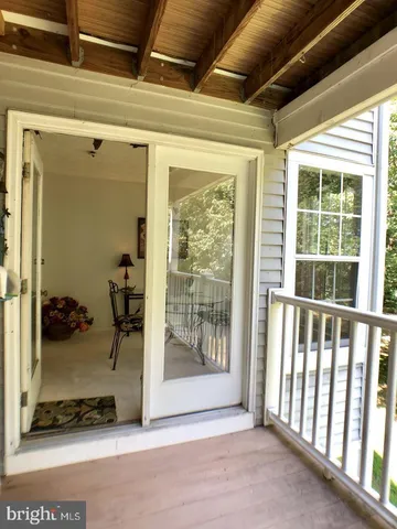 a view of a room with wooden floor and windows