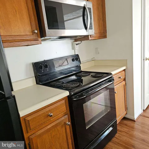 a stove top oven sitting inside of a kitchen