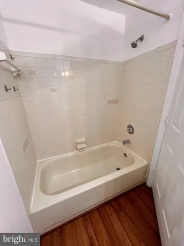 a bathroom with a tub a sink and a shower