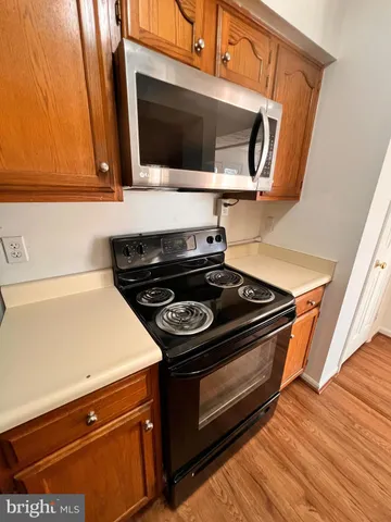 a stove top oven sitting inside of a kitchen